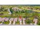 Aerial view showcasing the home's location on the golf course with mature trees at 23935 Coral Ridge Ln, Land O Lakes, FL 34639