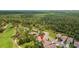 Scenic aerial view of the home on the golf course, surrounded by lush greenery and a tranquil pond at 23935 Coral Ridge Ln, Land O Lakes, FL 34639
