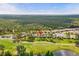 Beautiful aerial view of the property nestled amidst lush greenery and a scenic golf course at 23935 Coral Ridge Ln, Land O Lakes, FL 34639