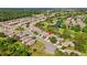 An aerial view shows a neighborhood and winding streets next to a manicured golf course and ponds at 23935 Coral Ridge Ln, Land O Lakes, FL 34639