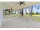 Large screened-in back porch with scenic views, a concrete floor, and ceiling fans at 23935 Coral Ridge Ln, Land O Lakes, FL 34639