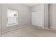 Simple bedroom featuring carpet, a large window with blinds, and a double-door closet at 23935 Coral Ridge Ln, Land O Lakes, FL 34639