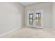Neutral bedroom with double doors leading to a back patio; carpeted with base molding at 23935 Coral Ridge Ln, Land O Lakes, FL 34639