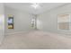 Spacious bedroom with neutral carpet, ceiling fan, and bright natural light from multiple windows at 23935 Coral Ridge Ln, Land O Lakes, FL 34639