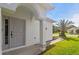Inviting front entrance with a classic gray front door, arched entryway and well-kept lawn at 23935 Coral Ridge Ln, Land O Lakes, FL 34639