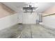 Unfinished garage with water heater, door to outside, and some shelving at 23935 Coral Ridge Ln, Land O Lakes, FL 34639