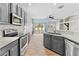 Well-equipped kitchen with stainless steel appliances, gray cabinetry, and wood tile flooring at 23935 Coral Ridge Ln, Land O Lakes, FL 34639