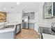 Modern kitchen features stainless steel appliances, gray cabinets, and wood tile flooring at 23935 Coral Ridge Ln, Land O Lakes, FL 34639