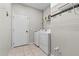 Functional laundry room with washer, dryer, wire shelving, and tiled floor at 23935 Coral Ridge Ln, Land O Lakes, FL 34639