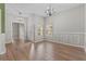 Traditional-style living room with hardwood floors, chair rail, and stylish chandeliers at 23935 Coral Ridge Ln, Land O Lakes, FL 34639