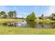 Scenic view of the home overlooking a tranquil pond and lush greenery, creating a peaceful setting at 23935 Coral Ridge Ln, Land O Lakes, FL 34639