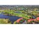 Expansive aerial shot of a golf course community with lakes, lush greenery, and residences with tile roofs at 2400 Feather Sound Dr # 735, Clearwater, FL 33762