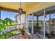 Balcony with a serene lake view, stylish tile flooring, and comfortable outdoor seating at 2400 Feather Sound Dr # 735, Clearwater, FL 33762