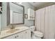 A functional bathroom with a granite countertop sink, framed mirror and shower/tub combo at 2400 Feather Sound Dr # 735, Clearwater, FL 33762