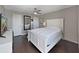Bedroom featuring a ceiling fan, white bed frame and dark hardwood flooring at 2400 Feather Sound Dr # 735, Clearwater, FL 33762