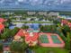 Aerial view featuring community amenities: pool, tennis courts, and clubhouse on the water at 2400 Feather Sound Dr # 735, Clearwater, FL 33762