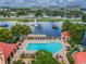 Aerial view showcasing the community pool with ample seating, lush landscaping, and nearby amenities at 2400 Feather Sound Dr # 735, Clearwater, FL 33762