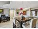 A dining area with a dark wood table and light upholstered chairs. A home office is also present at 2400 Feather Sound Dr # 735, Clearwater, FL 33762