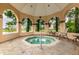 Community hot tub under gazebo with chairs overlooking a lake at 2400 Feather Sound Dr # 735, Clearwater, FL 33762