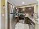 Modern kitchen with stainless steel appliances and dark wood cabinets at 2400 Feather Sound Dr # 735, Clearwater, FL 33762