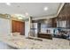 Open kitchen with granite countertops, stainless steel appliances, and ample cabinet space at 2400 Feather Sound Dr # 735, Clearwater, FL 33762