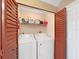 Functional laundry closet featuring a washer and dryer at 2400 Feather Sound Dr # 735, Clearwater, FL 33762