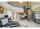 Bright and airy living space featuring an open floor plan, tile floors, a spiral staircase, and modern furnishings at 2400 Feather Sound Dr # 735, Clearwater, FL 33762