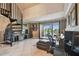 Spacious living room with a spiral staircase, comfortable seating, tile floors, and a balcony overlooking the waterfront at 2400 Feather Sound Dr # 735, Clearwater, FL 33762