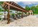 Lounge chairs under a pergola by the community pool at 2400 Feather Sound Dr # 735, Clearwater, FL 33762