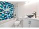 Bathroom with blue scalloped shower tiles, modern vanity, and a stylish vessel sink at 2700 Bayshore Blvd # 511, Dunedin, FL 34698