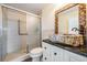 Unique bathroom featuring a stone vessel sink, decorative mirror, and a glass-enclosed shower at 2700 Bayshore Blvd # 511, Dunedin, FL 34698