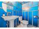 Whimsical bathroom with a pedestal sink, toilet, and custom shark-themed wall art and mirror at 2700 Bayshore Blvd # 511, Dunedin, FL 34698