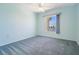 Bright bedroom featuring a window with scenic water view and blue carpeting at 2700 Bayshore Blvd # 511, Dunedin, FL 34698