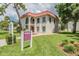 Manor Club property office exterior featuring well-maintained landscaping and red roof tiles at 2700 Bayshore Blvd # 511, Dunedin, FL 34698