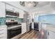 Bright kitchen with stainless steel appliances, mosaic backsplash, and a wine refrigerator at 2700 Bayshore Blvd # 511, Dunedin, FL 34698
