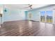 Spacious living room with wood floors, natural light, and sliding door to patio with a water view at 2700 Bayshore Blvd # 511, Dunedin, FL 34698