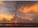 Breathtaking sunset over the water with vibrant orange and yellow hues illuminating the sky at 2700 Bayshore Blvd # 511, Dunedin, FL 34698
