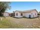 Backyard showcasing a screened in patio, shed, lawn, and well-maintained landscaping, providing a private outdoor space at 2702 Ochatilla Rd, Holiday, FL 34691