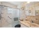 Bathroom featuring a walk-in shower with glass door and a vanity sink with built-in storage at 2702 Ochatilla Rd, Holiday, FL 34691