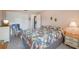 Cozy bedroom with a floral comforter and a chair with a cat sitting in it at 2702 Ochatilla Rd, Holiday, FL 34691