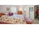 Cozy bedroom featuring floral bedding, a wooden dresser, and an ensuite bathroom for added convenience at 2702 Ochatilla Rd, Holiday, FL 34691