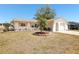 Well-maintained single Gathering home featuring mature landscaping with palm trees on a sunny day at 2702 Ochatilla Rd, Holiday, FL 34691