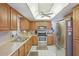 Traditional kitchen featuring wooden cabinets, stainless steel appliances, and a ceiling fan at 2702 Ochatilla Rd, Holiday, FL 34691