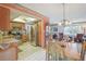 Open-concept kitchen with stainless steel appliances flowing into a dining and living area at 2702 Ochatilla Rd, Holiday, FL 34691
