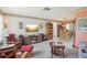 Cozy living room with plush seating, a tv, open dining area, and adjacent kitchen views at 2702 Ochatilla Rd, Holiday, FL 34691