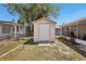 Exterior of the home's shed with white siding in the well-maintained lawn at 2702 Ochatilla Rd, Holiday, FL 34691