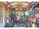 Interior view of shed and its contents, the shed has wooden beams and stores gardening equipment at 2702 Ochatilla Rd, Holiday, FL 34691