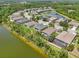 Overhead perspective of a community bordering a pond with numerous houses and green space at 2803 130Th E Ave, Parrish, FL 34219