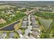 Aerial view of a neighborhood with beautiful lakes and lush greenery at 2803 130Th E Ave, Parrish, FL 34219