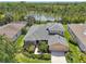 Aerial view of this property with beautiful landscaping and a serene lake view in the background at 2803 130Th E Ave, Parrish, FL 34219